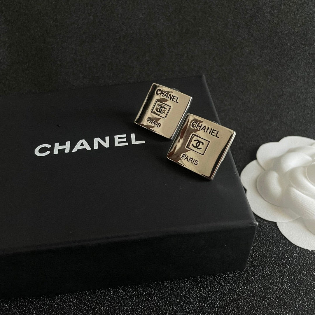 Double-C Emblem Stud Earrings in Polished Metal-Tone – Design 265 detail view