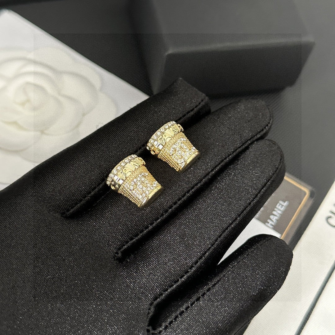 Martin Graham stud earrings in polished metal-tone – close-up detail