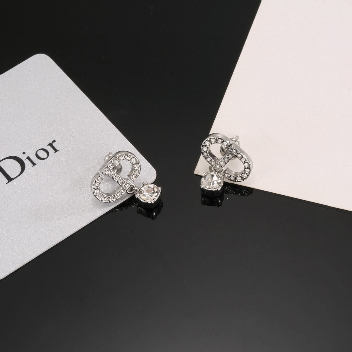 Martin Graham stud earrings in polished metal-tone – close-up detail