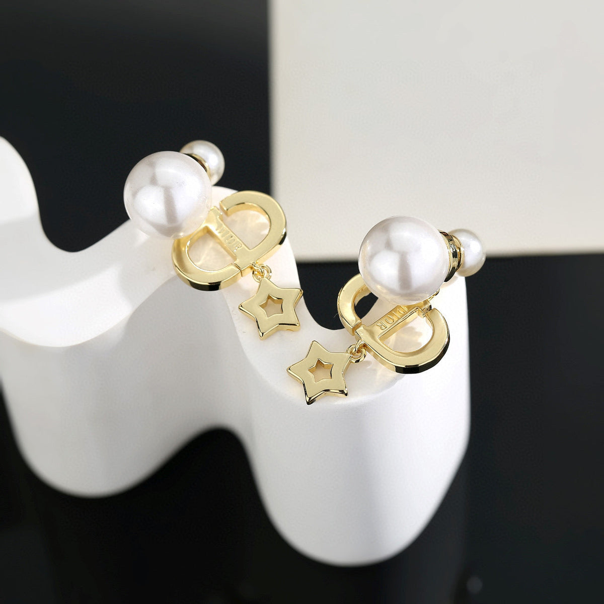 Martin Graham stud earrings in polished metal-tone – close-up detail