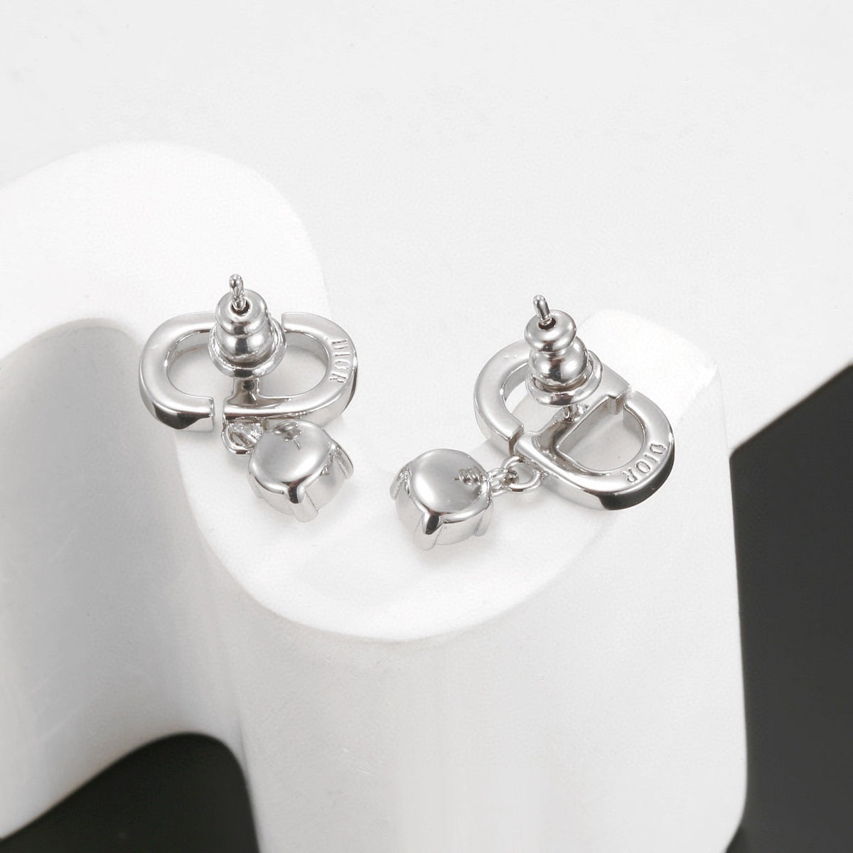 Martin Graham stud earrings in polished metal-tone – close-up detail