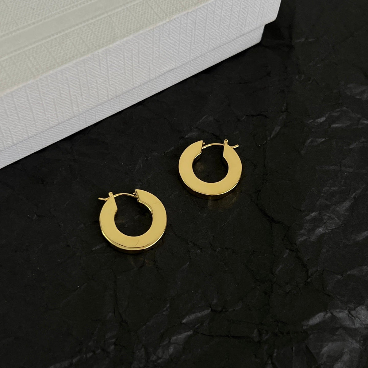 Martin Graham earrings in polished metal-tone