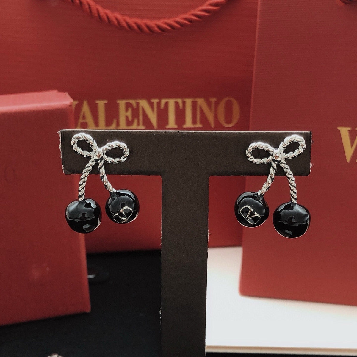 Martin Graham stud earrings in polished metal-tone – front view