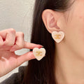 Double-C Emblem Stud Earrings in Polished Metal-Tone – Heart Detail – Design 015 main product view