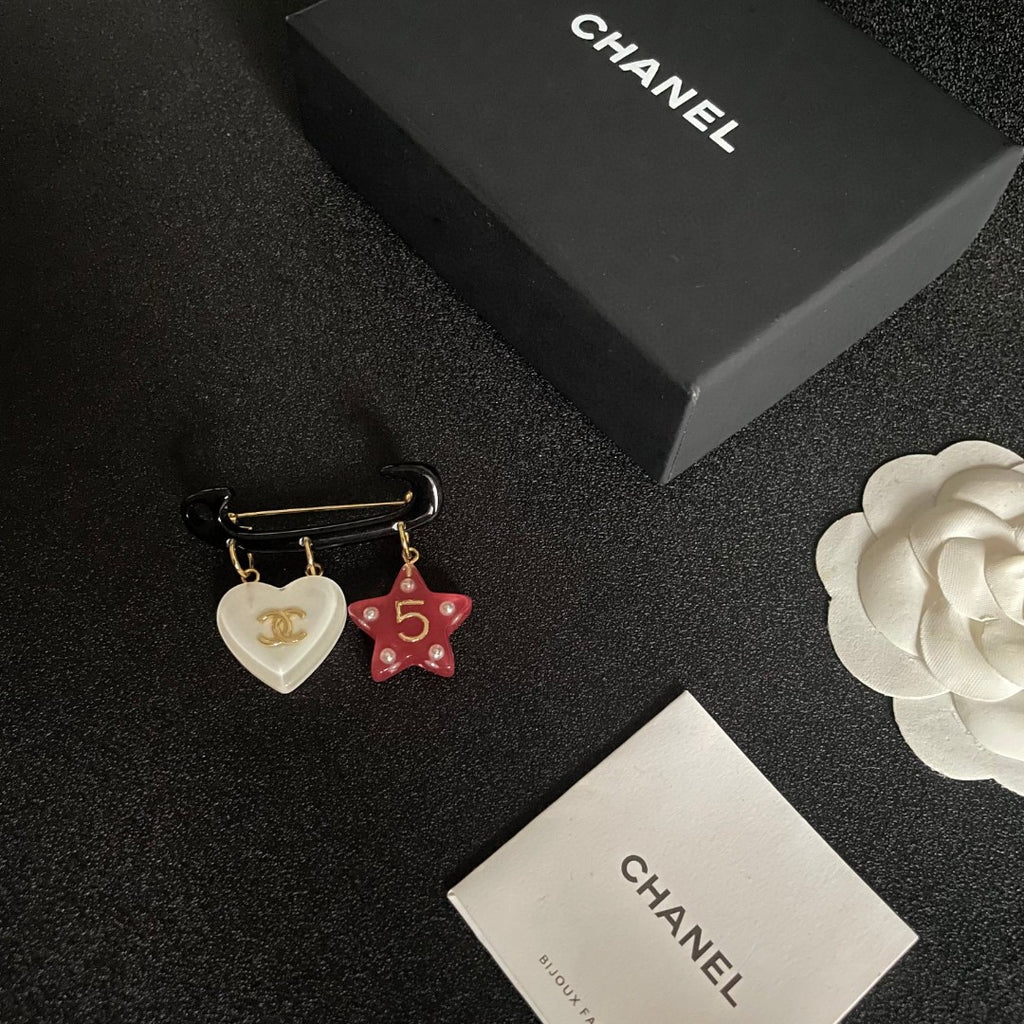 Double-C Emblem Brooch in Polished Metal-Tone – Star Detail close-up detail