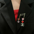 Double-C Emblem Brooch in Polished Metal-Tone – Heart Detail main product view