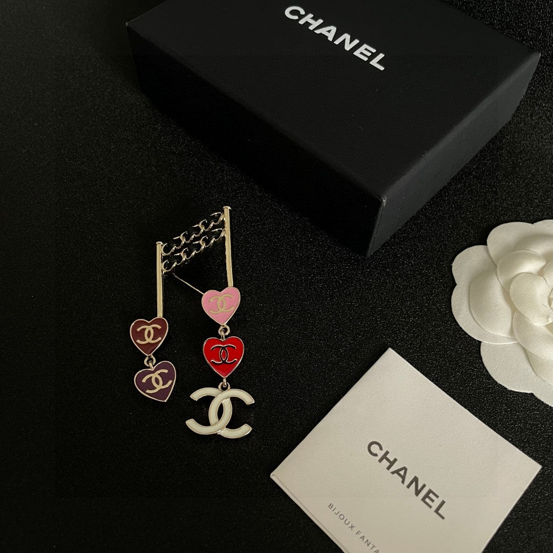 Double-C Emblem Brooch in Polished Metal-Tone – Heart Detail close-up detail