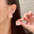 Letter Emblem Stud Earrings in Polished Metal-Tone – Square Detail – Design 002 main product view
