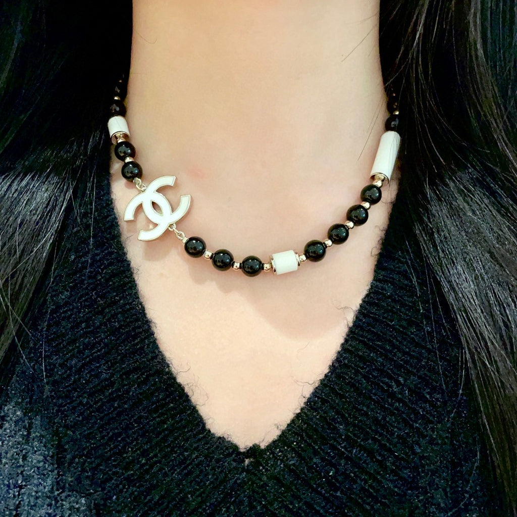 Double-C Emblem Pendant Necklace in Polished Metal-Tone – Black Detail detail view