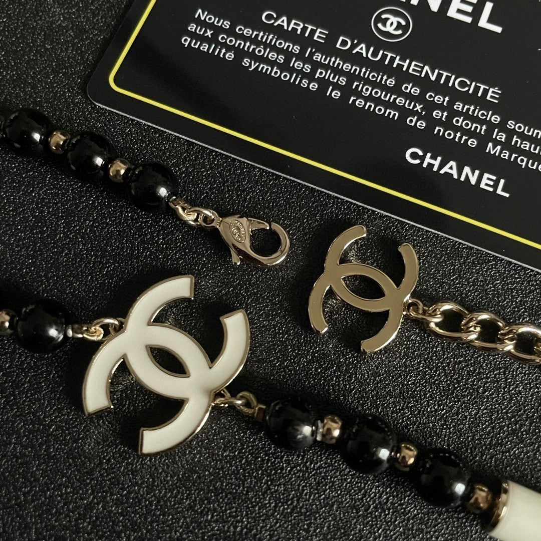 Double-C Emblem Pendant Necklace in Polished Metal-Tone – Black Detail front product view