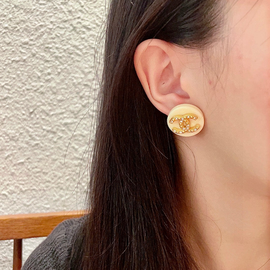 Double-C Emblem Stud Earrings in Polished Metal-Tone – Design 220 detail view