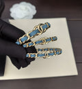 Signature Emblem Bangle in Gold-Tone – Blue Detail main product view