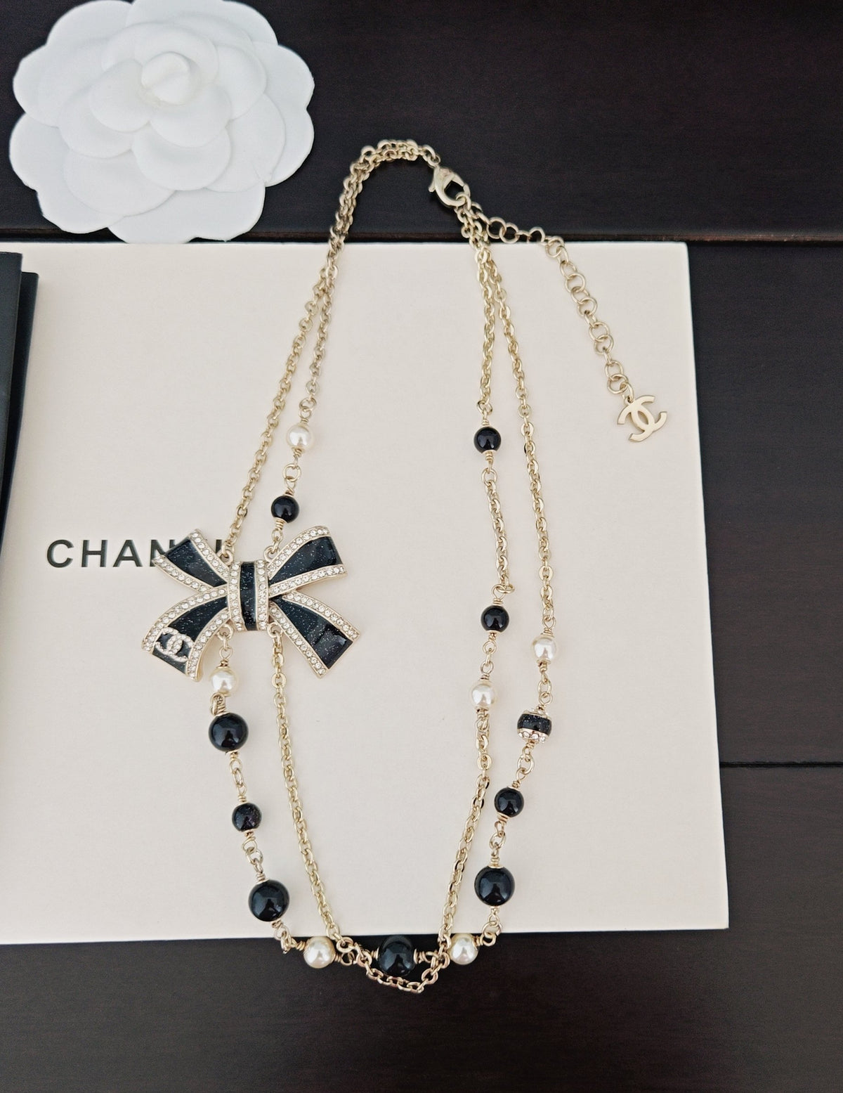 Bow Pendant Necklace in Gold-Tone – Black Detail styled product view