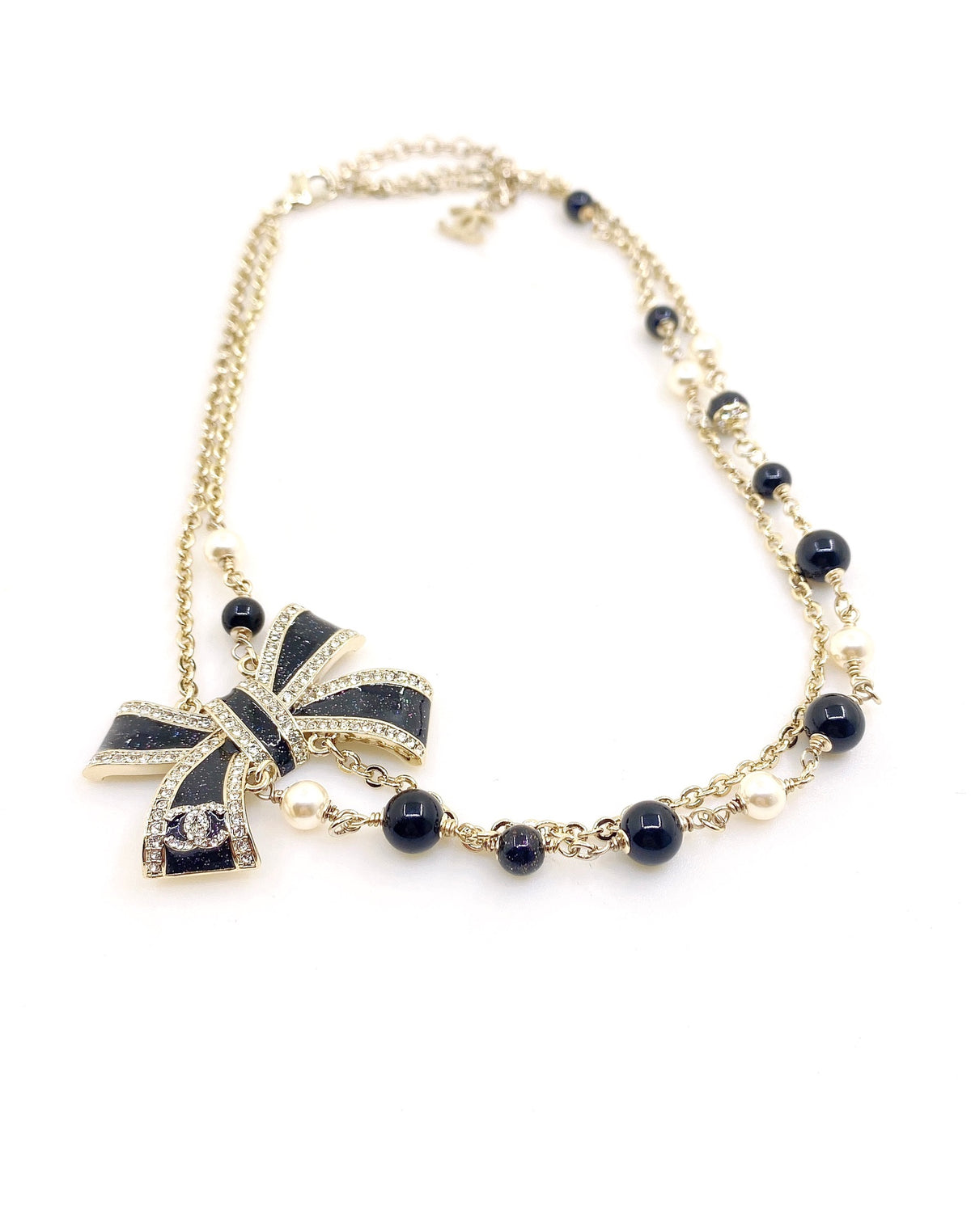 Bow Pendant Necklace in Gold-Tone – Black Detail detail view