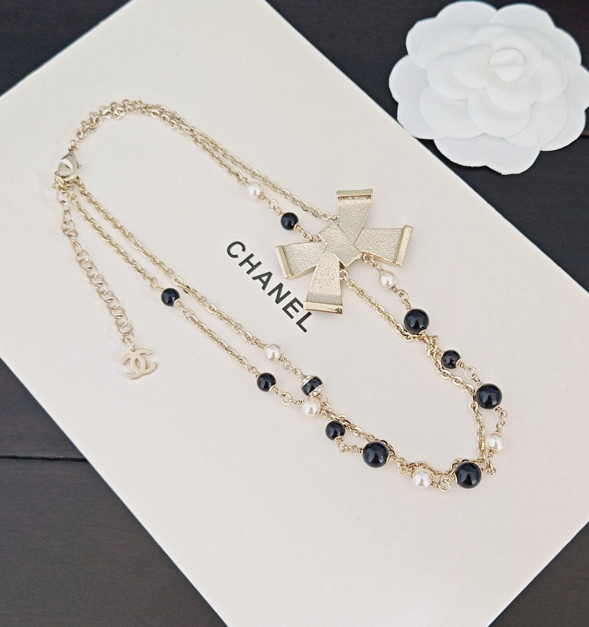 Bow Pendant Necklace in Gold-Tone – Black Detail side detail