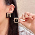 Double-C Emblem Stud Earrings in Polished Metal-Tone – Design 388 main product view