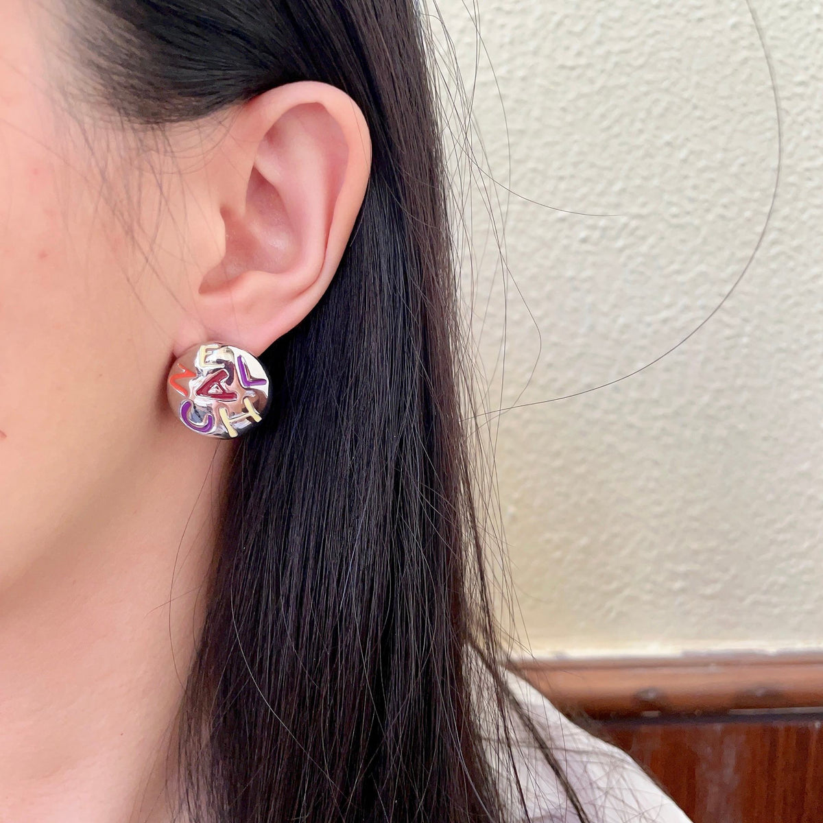 Double-C Emblem Stud Earrings in Polished Metal-Tone – Design 244 detail view