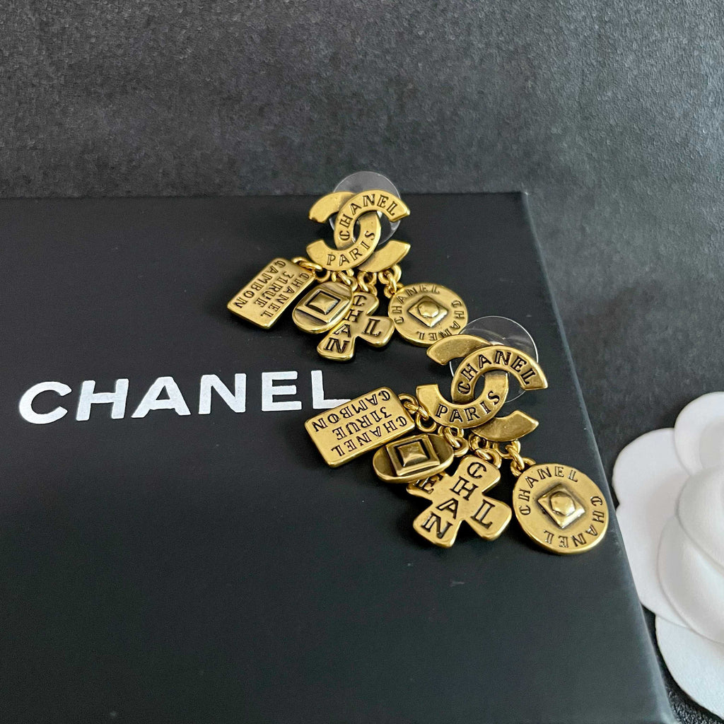 Double-C Emblem Stud Earrings in Polished Metal-Tone – Design 450 detail view