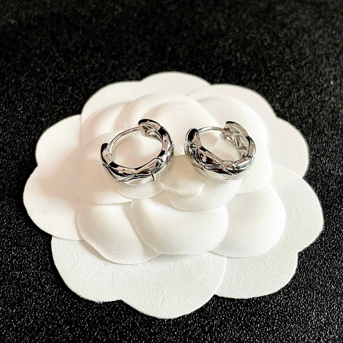Double-C Emblem Stud Earrings in Polished Metal-Tone – Design 130 front product view