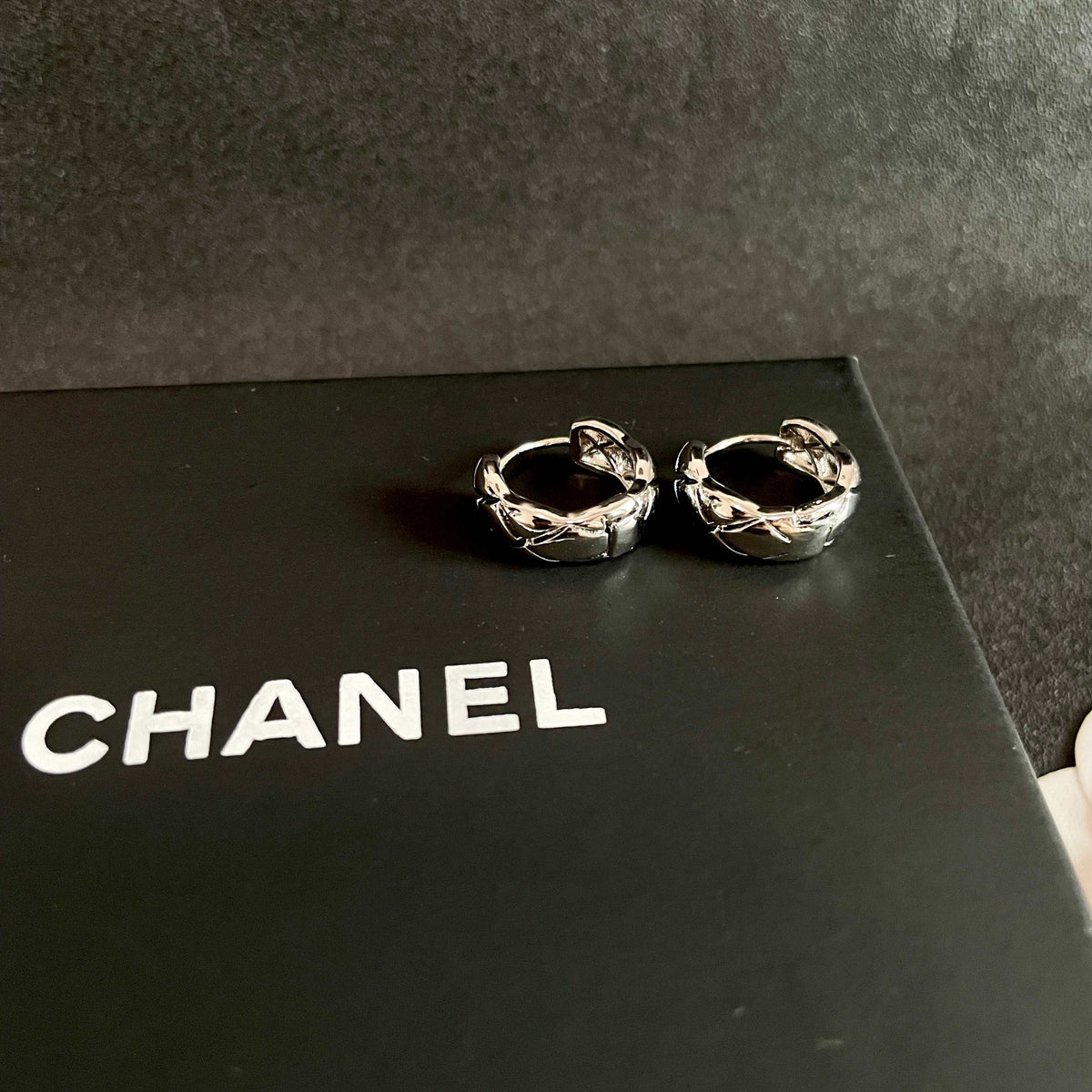 Double-C Emblem Stud Earrings in Polished Metal-Tone – Design 130 detail view