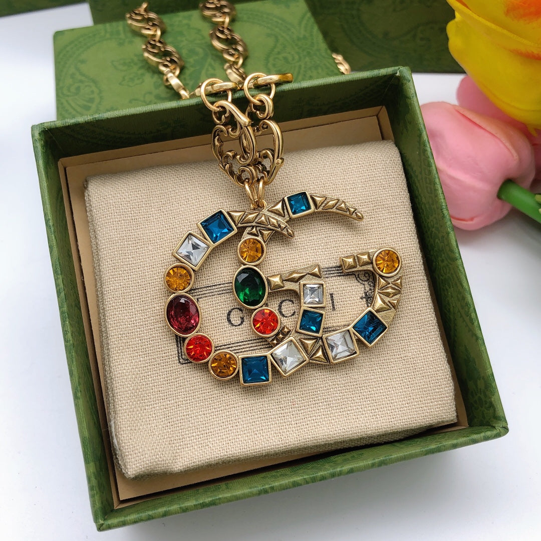 Double-G Emblem Pendant Necklace in Polished Metal-Tone – Crystal Detail detail view
