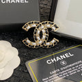Signature Emblem Brooch in Polished Metal-Tone – Black Detail main product view
