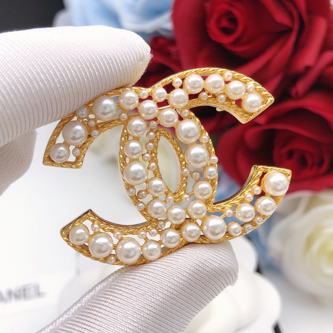 Double-C Emblem Brooch in Gold-Tone – Pearl Detail detail view