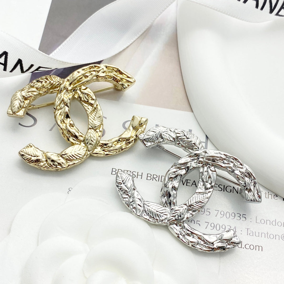 Double-C Emblem Brooch in Polished Metal-Tone – Design 064 detail view
