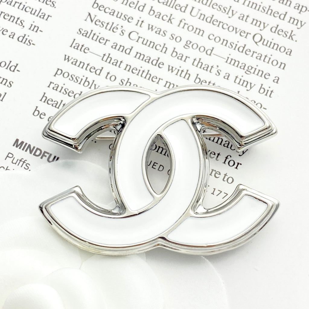 Double-C Emblem Brooch in Polished Metal-Tone – White Detail detail view