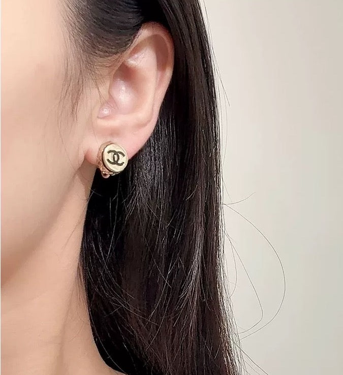 Signature Emblem Stud Earrings in Polished Metal-Tone – Pink Detail front product view