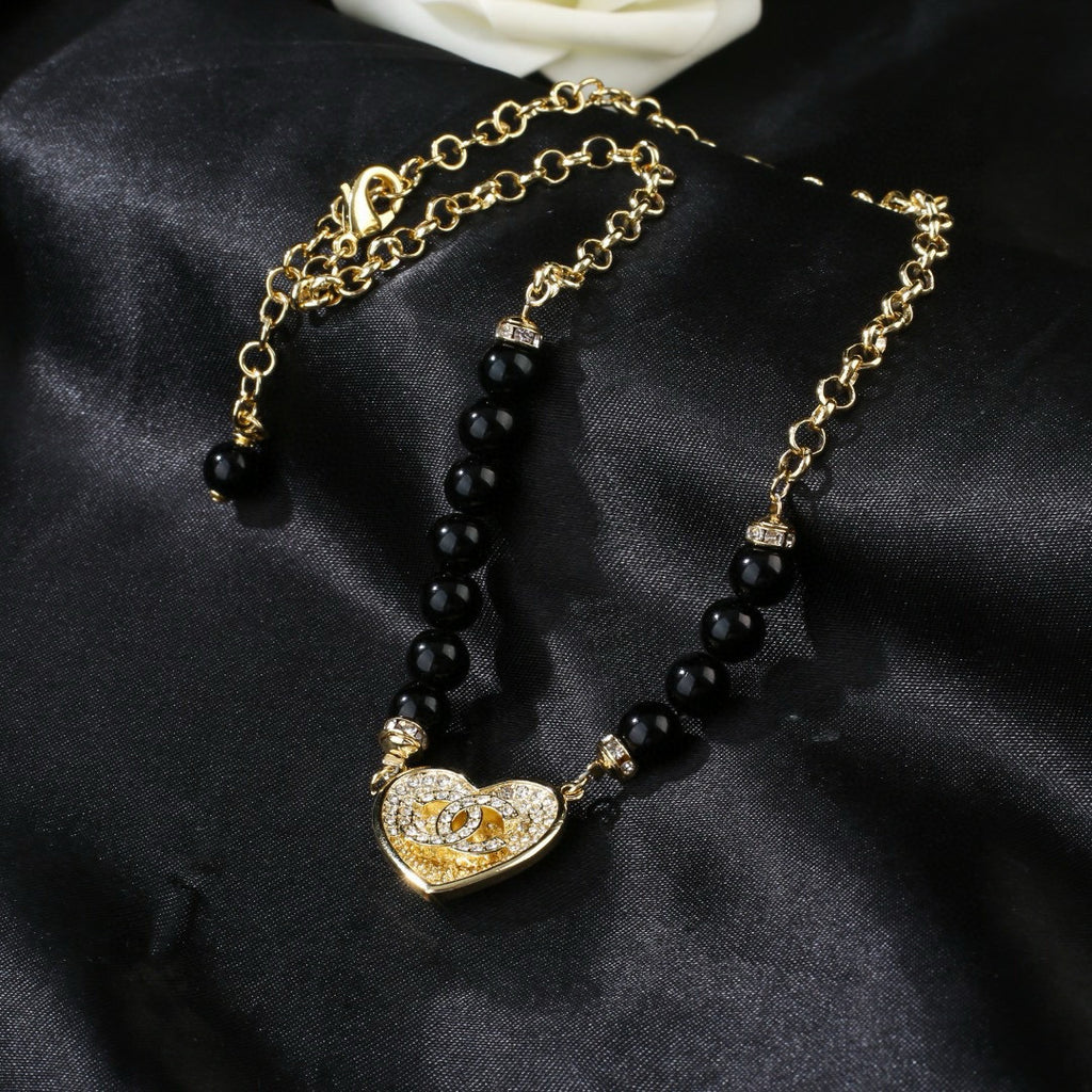 Double-C Emblem Pendant Necklace in Gold-Tone – Heart Detail close-up detail