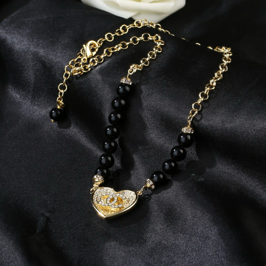 Double-C Emblem Pendant Necklace in Gold-Tone – Heart Detail close-up detail