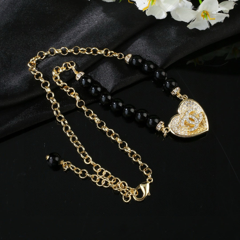 Double-C Emblem Pendant Necklace in Gold-Tone – Heart Detail detail view