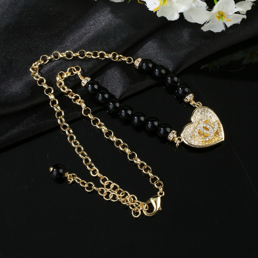 Double-C Emblem Pendant Necklace in Gold-Tone – Heart Detail detail view
