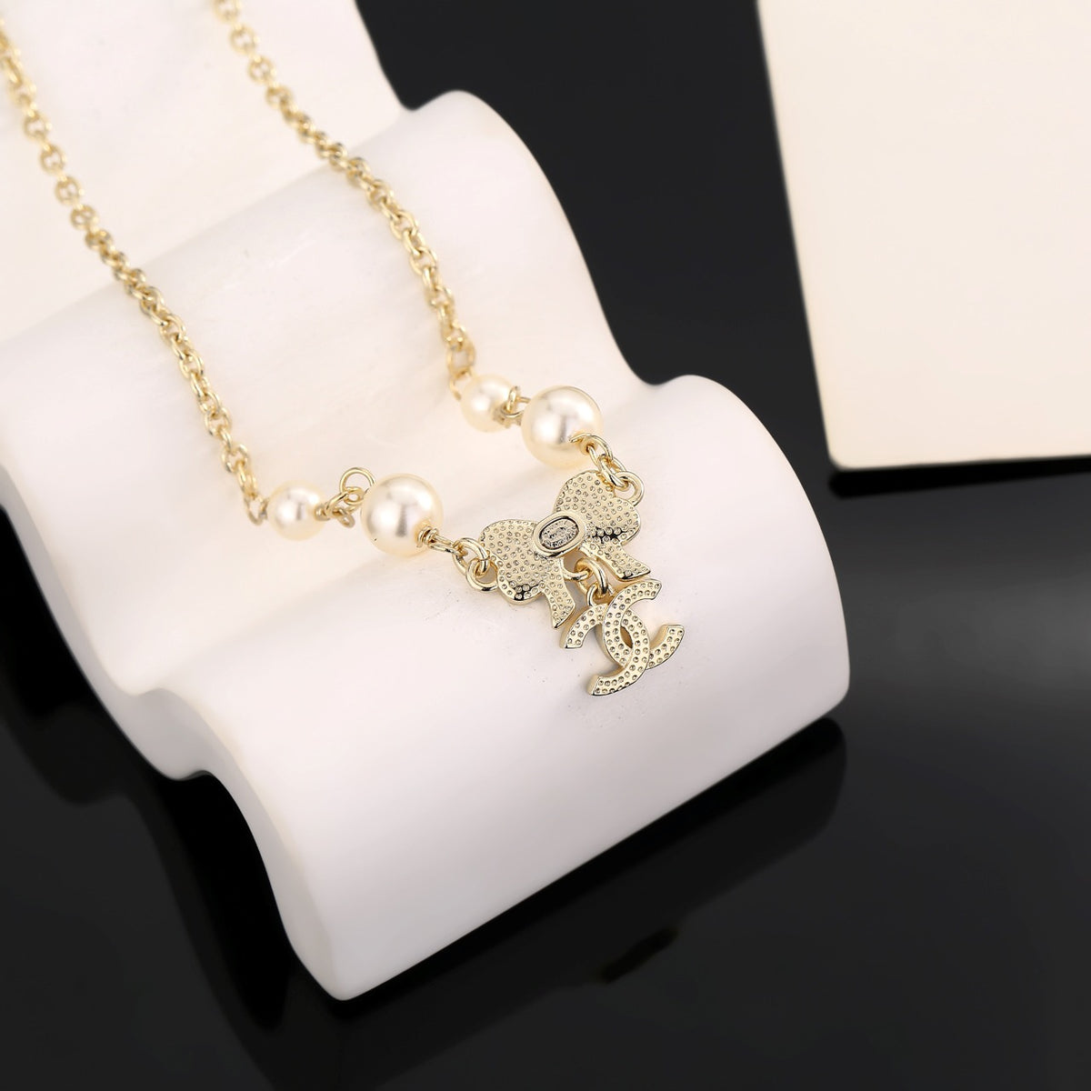 Bow Pendant Necklace in Polished Metal-Tone side detail