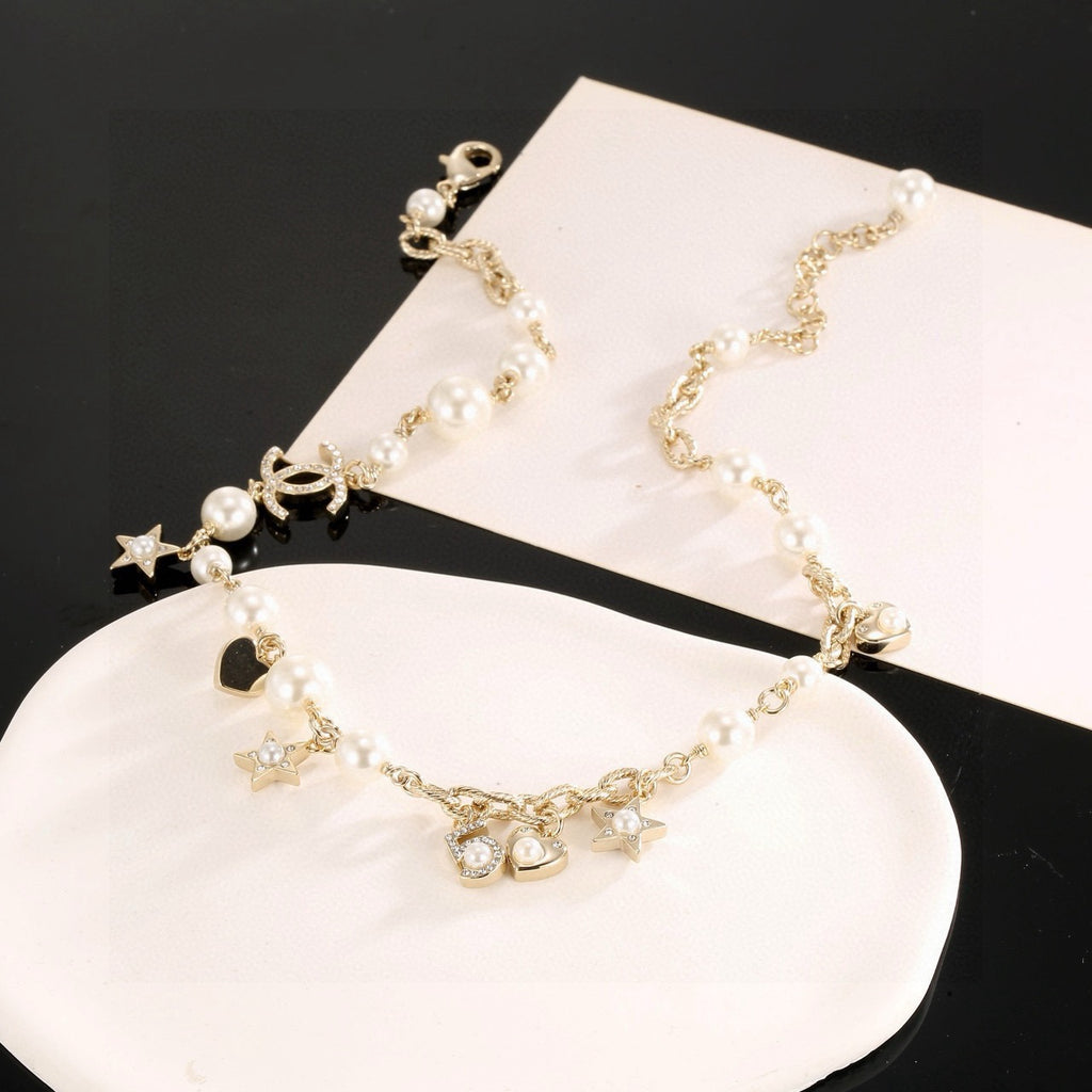 Double-C Emblem Pendant Necklace in Polished Metal-Tone – Star Detail styled product view