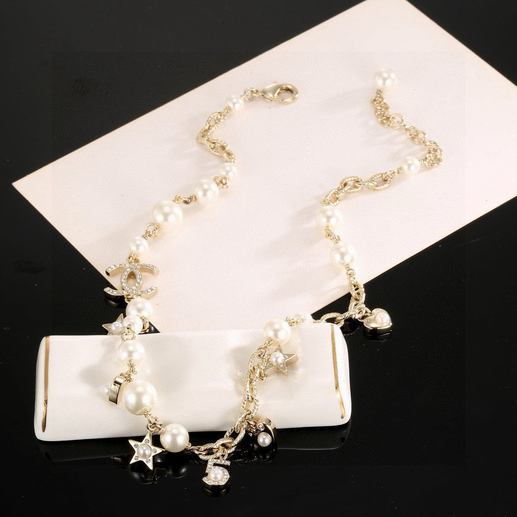 Double-C Emblem Pendant Necklace in Polished Metal-Tone – Star Detail main product view