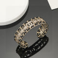 Signature Emblem Bangle in Polished Metal-Tone – Black Detail – Design 007 main product view