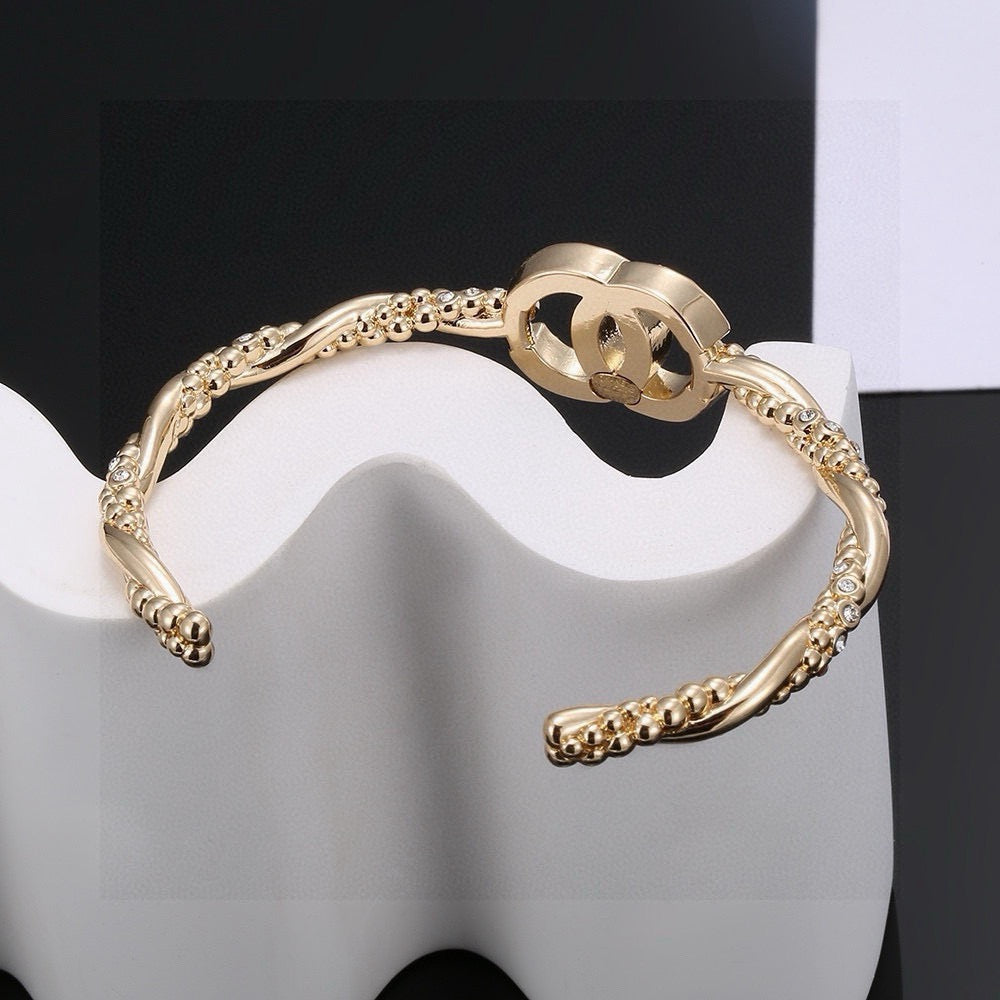 Signature Emblem Bangle in Polished Metal-Tone – Design 021 detail view