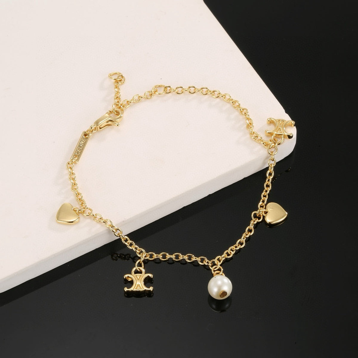 Signature Emblem Bracelet in Polished Metal-Tone – Red Detail close-up detail