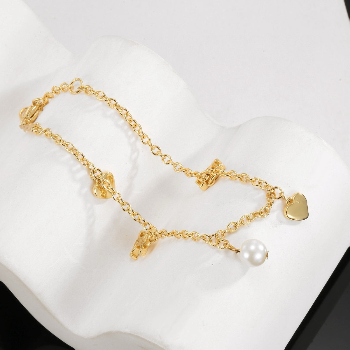 Signature Emblem Bracelet in Polished Metal-Tone – Red Detail front product view