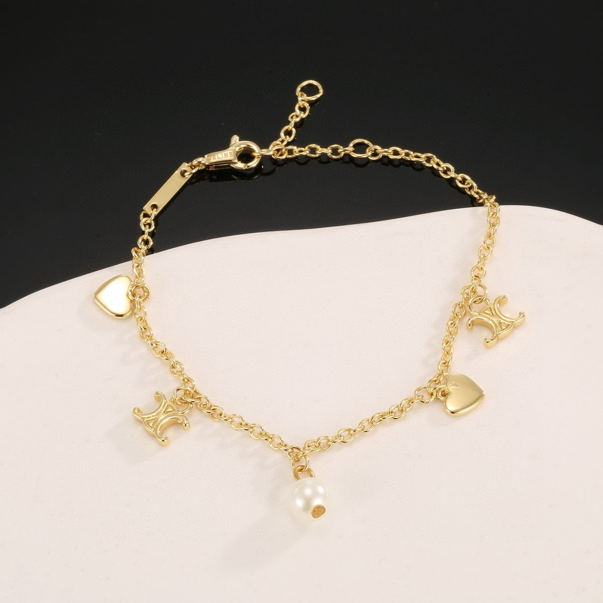 Signature Emblem Bracelet in Polished Metal-Tone – Red Detail styled product view