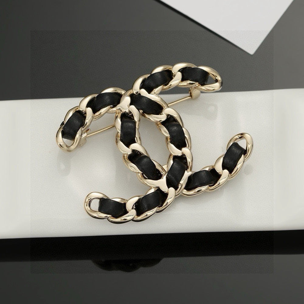 Signature Emblem Brooch in Polished Metal-Tone – Black Detail – Design 002 close-up detail