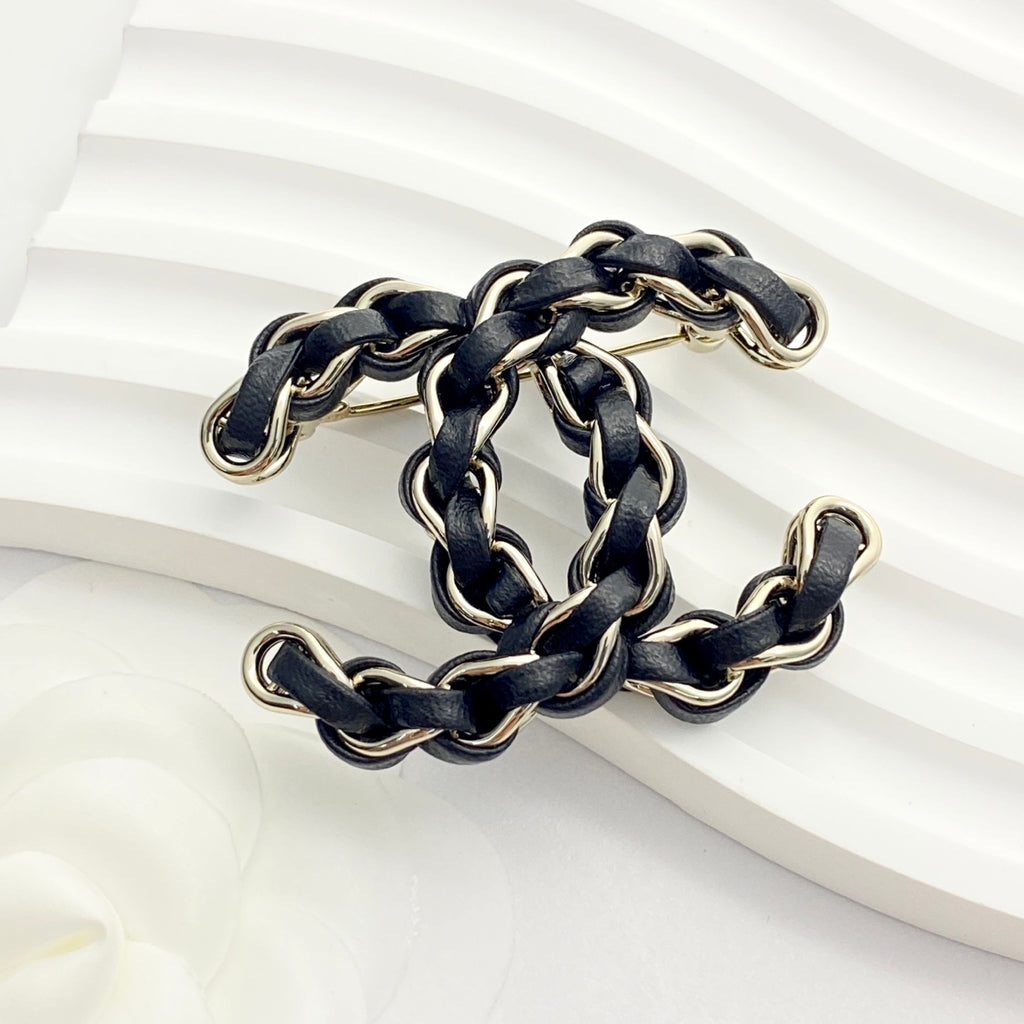 Signature Emblem Brooch in Polished Metal-Tone – Black Detail – Design 003 close-up detail