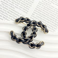 Signature Emblem Brooch in Polished Metal-Tone – Black Detail – Design 003 main product view
