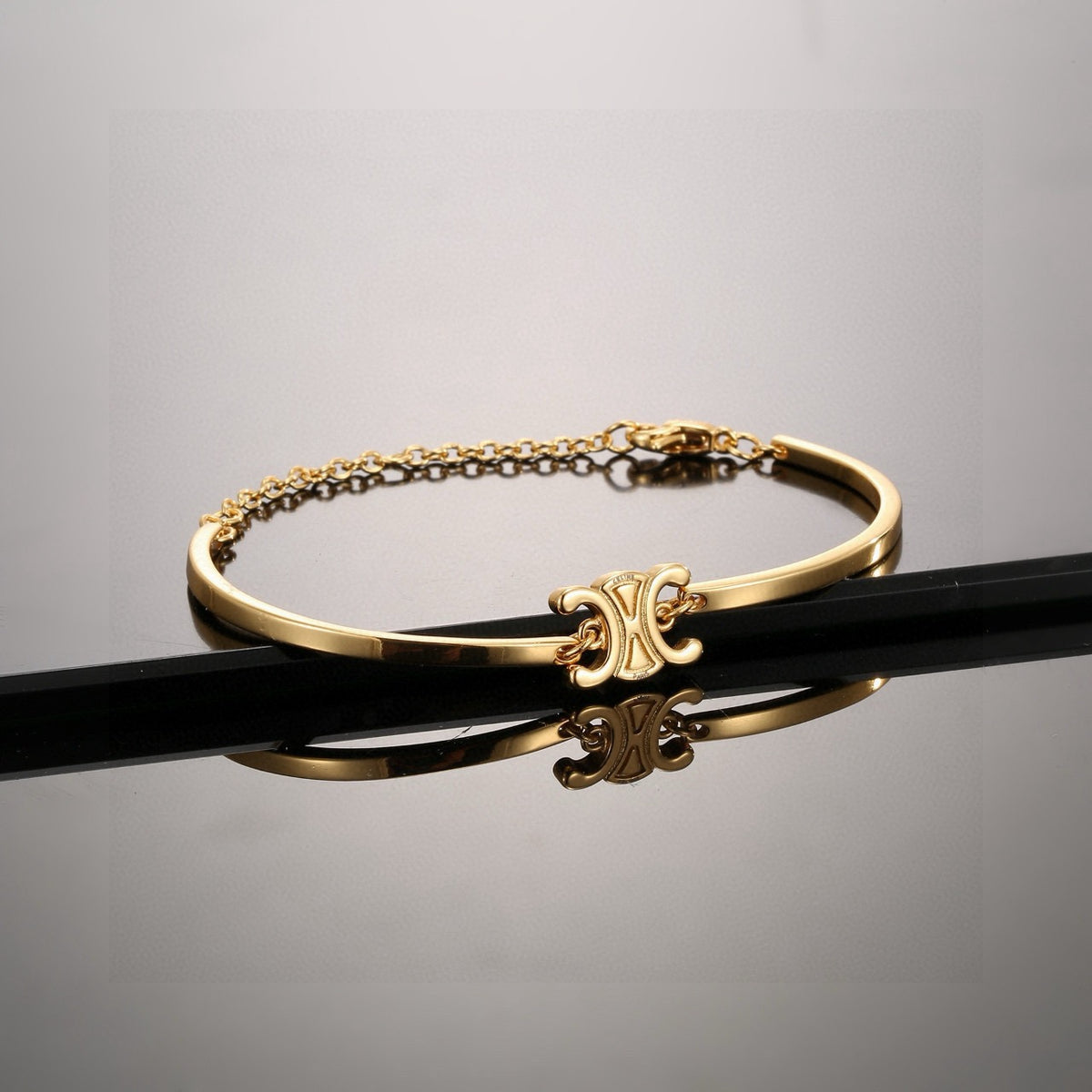 Signature Emblem Bangle in Polished Metal-Tone – Red Detail front product view