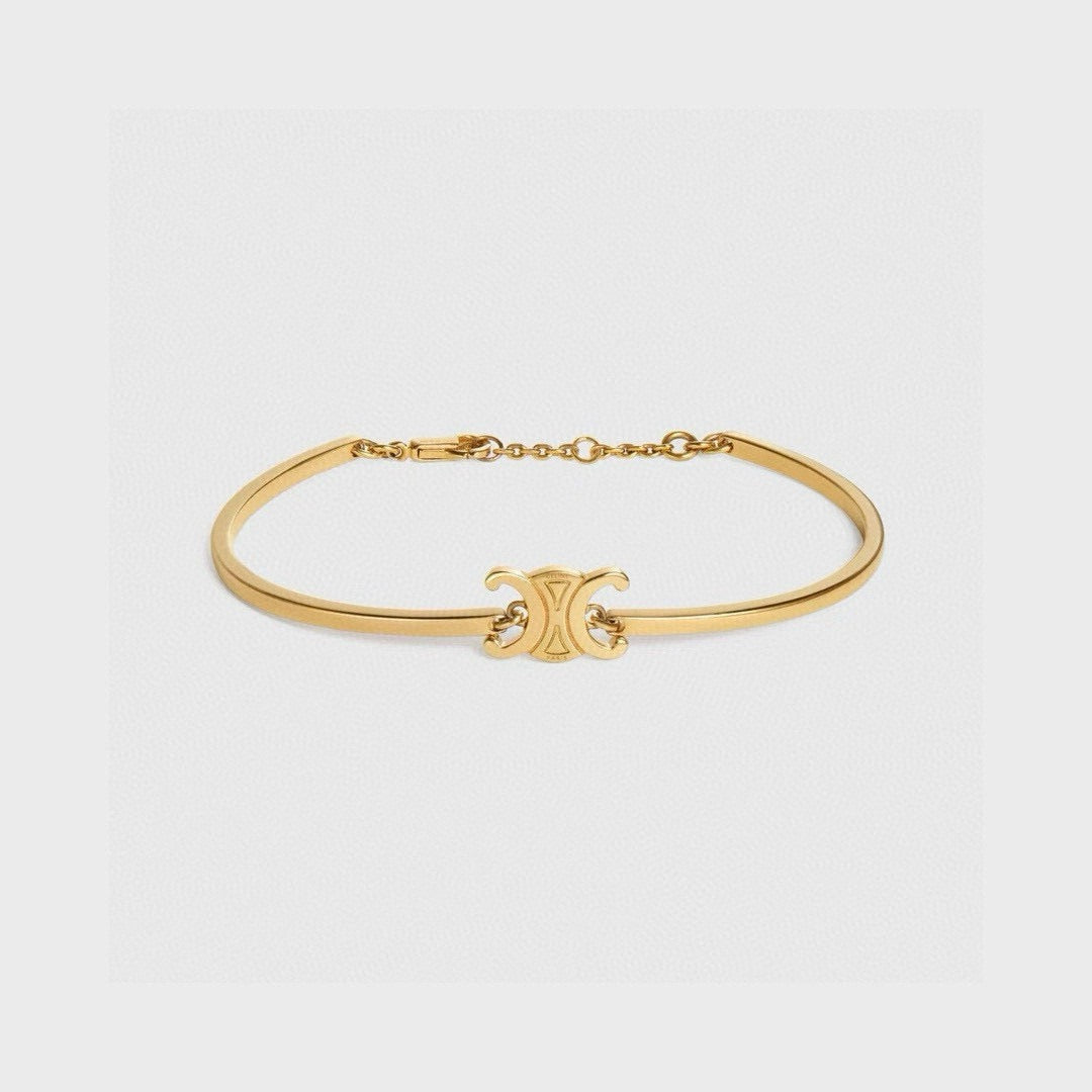 Signature Emblem Bangle in Polished Metal-Tone – Red Detail styled product view
