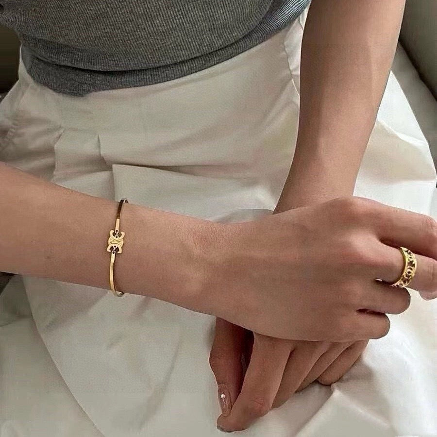 Signature Emblem Bangle in Polished Metal-Tone – Red Detail detail view