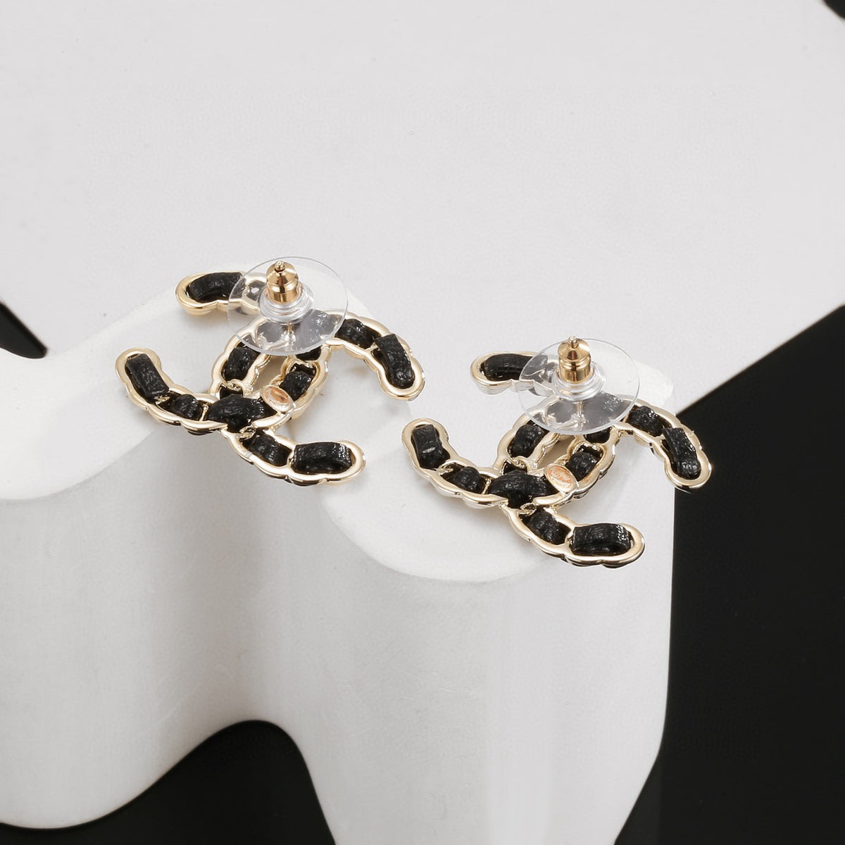 Signature Emblem Stud Earrings in Polished Metal-Tone – Black Detail – Design 002 close-up detail