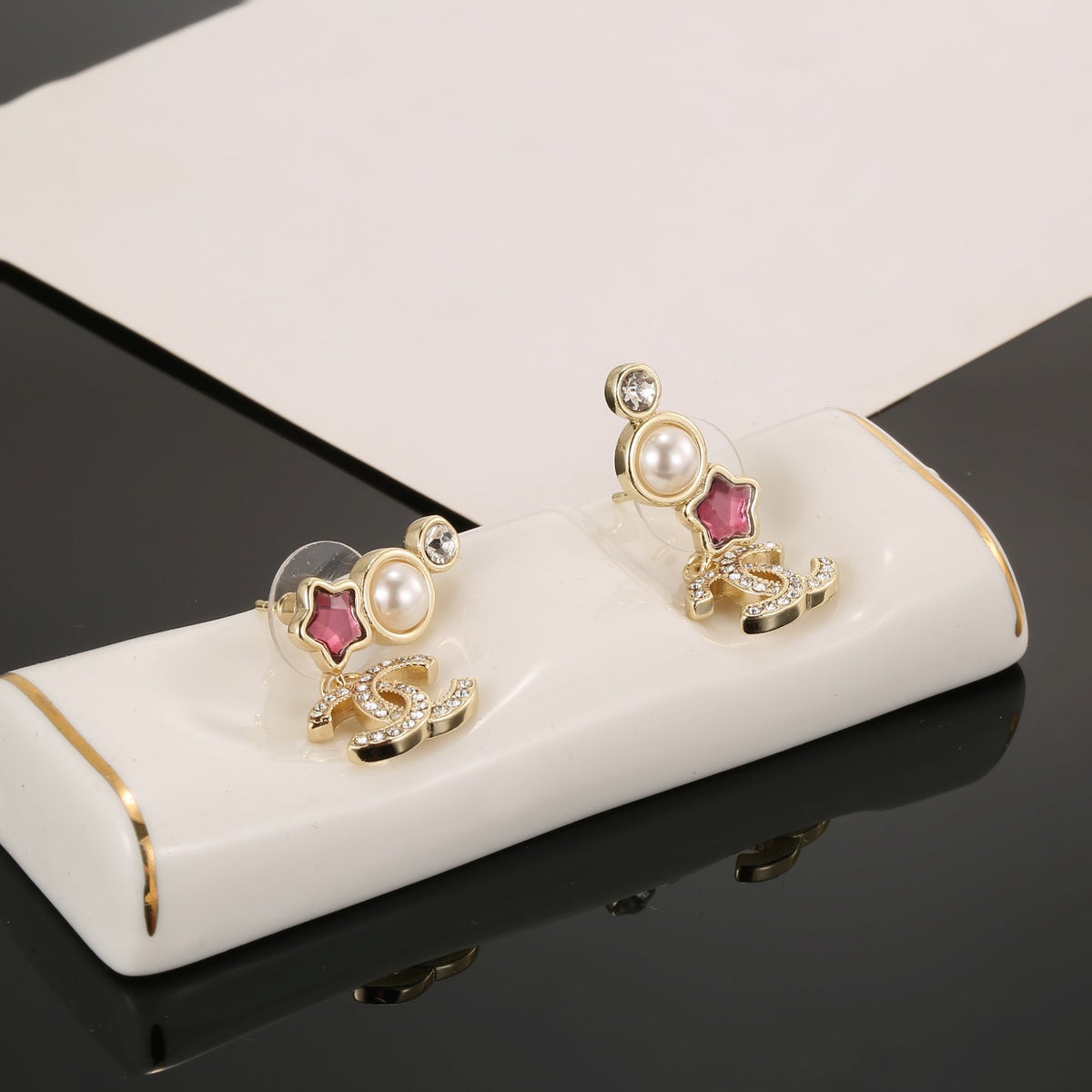 Double-C Emblem Stud Earrings in Gold-Tone – Star Detail – Design 008 detail view